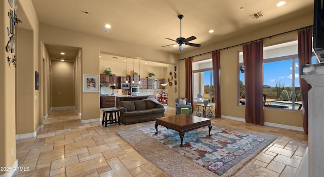 36813 N 109th Way, Scottsdale, AZ 85262 - living room featuring stone tile flooring, a ceiling fan, and recessed lighting