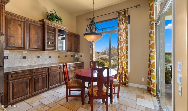 36813 N 109th Way, Scottsdale, AZ 85262 - dining room featuring stone tile flooring, healthy amount of natural light, and a chandelier