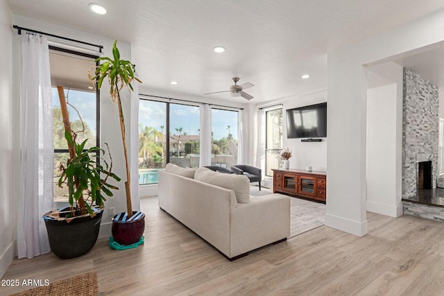 12015 S Tuzigoot Dr, Phoenix, AZ 85044 - living room featuring light wood finished floors, a ceiling fan, recessed lighting, baseboards, and a fireplace