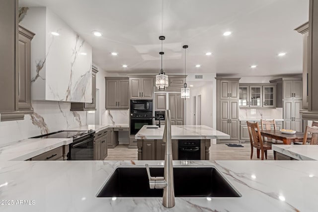 12015 S Tuzigoot Dr, Phoenix, AZ 85044 - kitchen with gray cabinetry, black appliances, tasteful backsplash, recessed lighting, and light stone counters