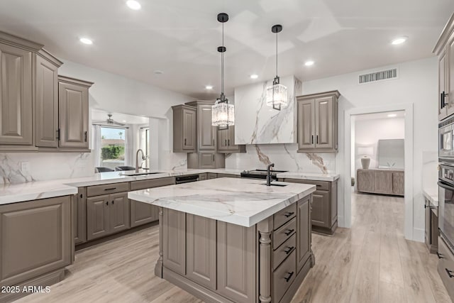 12015 S Tuzigoot Dr, Phoenix, AZ 85044 - kitchen with gray cabinetry, a sink, a kitchen island with sink, backsplash, and recessed lighting