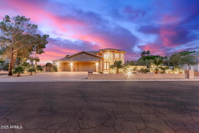 12015 S Tuzigoot Dr, Phoenix, AZ 85044 - mediterranean / spanish-style home with an attached garage, concrete driveway, and stucco siding