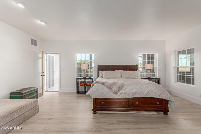 12015 S Tuzigoot Dr, Phoenix, AZ 85044 - bedroom featuring multiple windows, light wood-type flooring, and baseboards