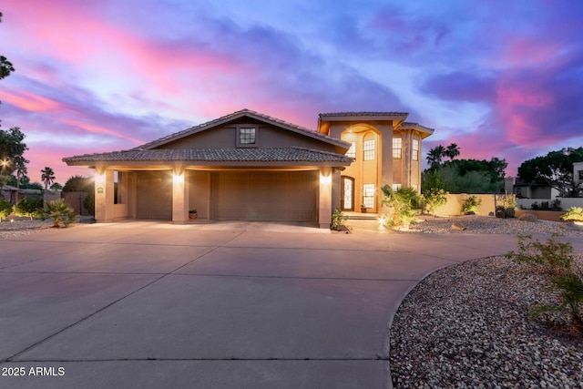 12015 S Tuzigoot Dr, Phoenix, AZ 85044 - view of front facade with concrete driveway, stucco siding, a tiled roof, and an attached garage