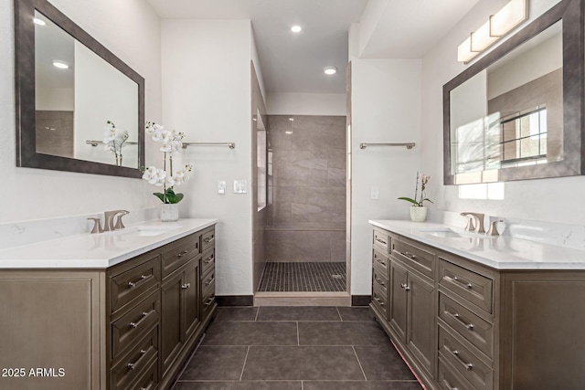 12015 S Tuzigoot Dr, Phoenix, AZ 85044 - full bath featuring two vanities, tiled shower, tile patterned flooring, and baseboards