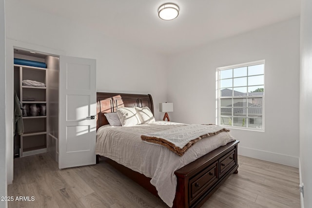12015 S Tuzigoot Dr, Phoenix, AZ 85044 - bedroom featuring light wood-style flooring and baseboards