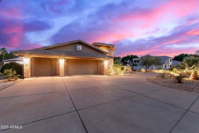 12015 S Tuzigoot Dr, Phoenix, AZ 85044 - view of front of home featuring driveway, a tiled roof, a garage, and stucco siding