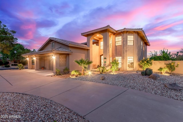 12015 S Tuzigoot Dr, Phoenix, AZ 85044 - mediterranean / spanish-style home with stucco siding, a tiled roof, an attached garage, and driveway