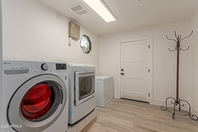 12015 S Tuzigoot Dr, Phoenix, AZ 85044 - laundry area with independent washer and dryer and light wood-style flooring