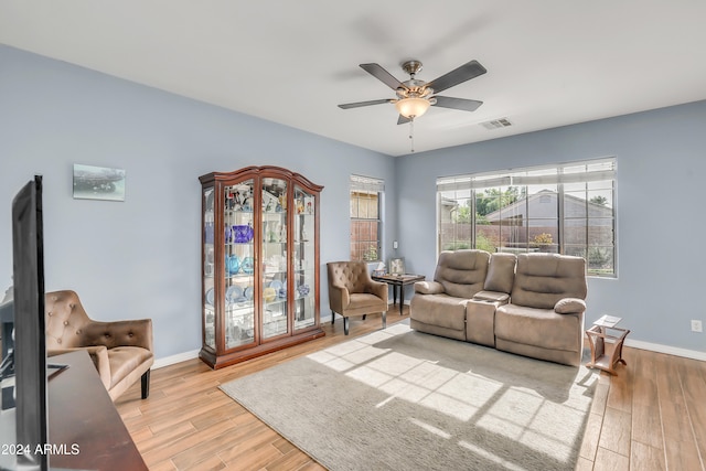 living room featuring ceiling fan and light hardwood / wood-style floors