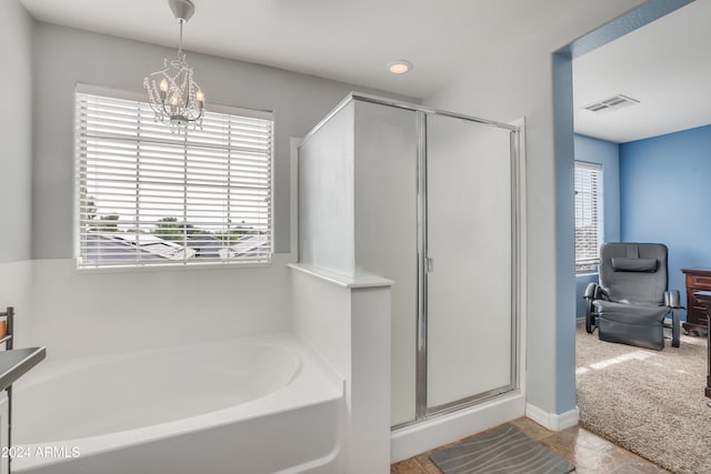 bathroom featuring a chandelier and plus walk in shower