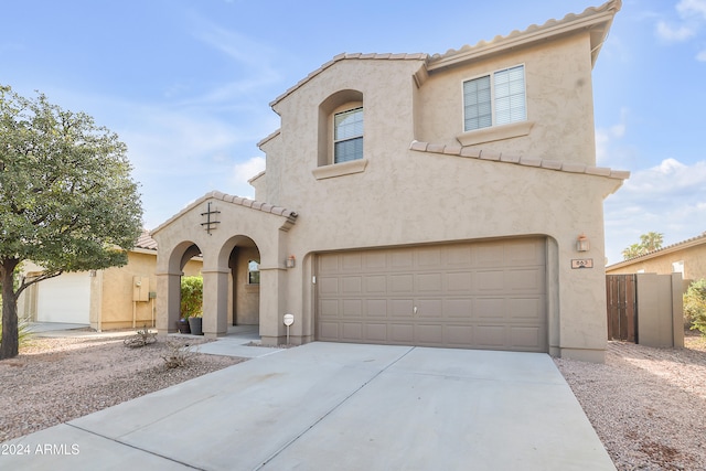 mediterranean / spanish-style home featuring a garage