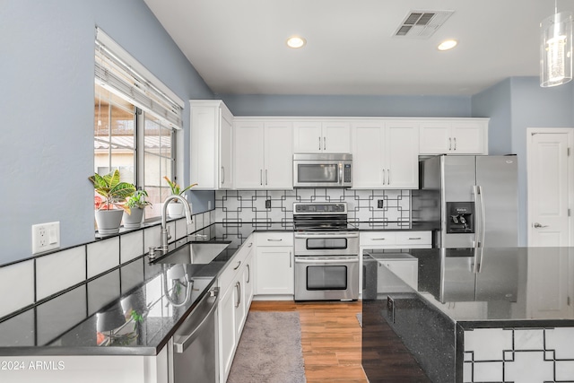 kitchen featuring white cabinetry, sink, and appliances with stainless steel finishes