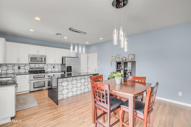 dining area with light hardwood / wood-style flooring