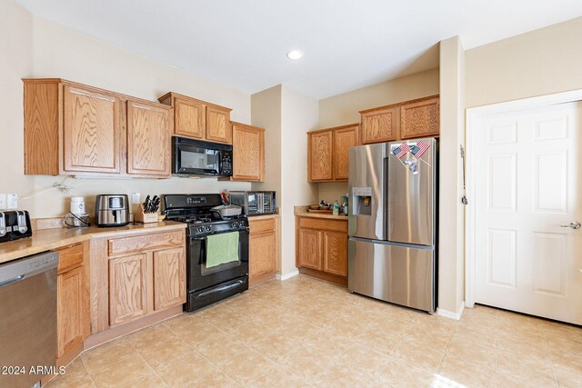 kitchen featuring light tile patterned floors and black appliances