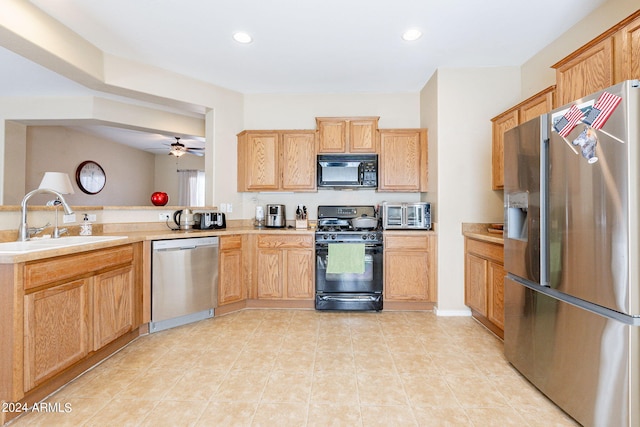 kitchen featuring light tile patterned flooring, sink, ceiling fan, and black appliances