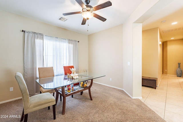 tiled dining space featuring ceiling fan