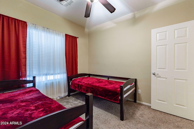 bedroom with ceiling fan and light carpet