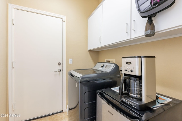 washroom with cabinets and washer and dryer