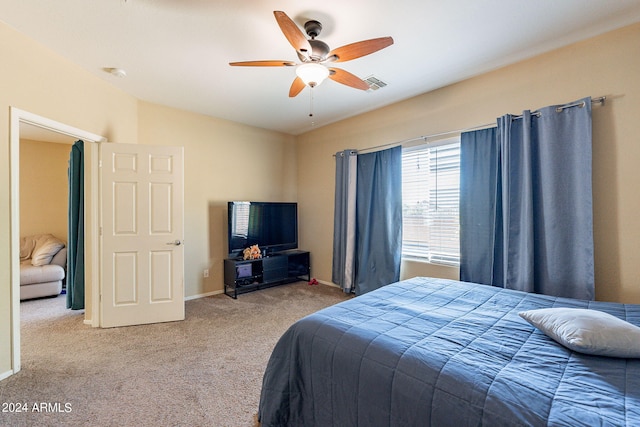 bedroom featuring light carpet and ceiling fan