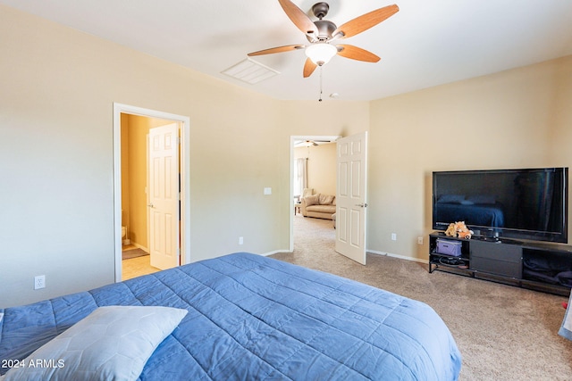 carpeted bedroom featuring ensuite bath and ceiling fan