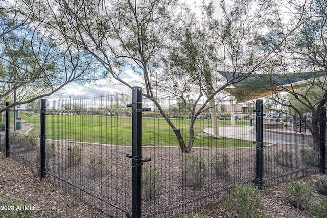 view of gate featuring a lawn