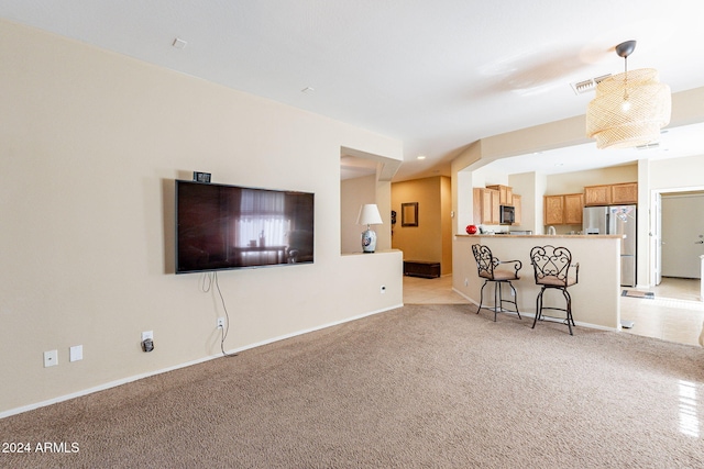 unfurnished living room featuring light colored carpet