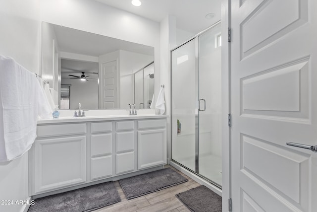 bathroom with vanity, ceiling fan, hardwood / wood-style flooring, and walk in shower