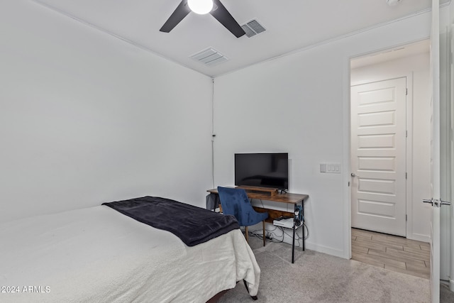 bedroom with light hardwood / wood-style floors and ceiling fan