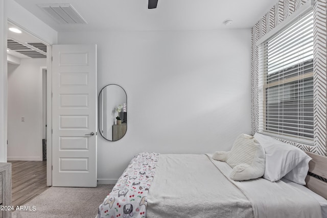 bedroom with light wood-type flooring and ceiling fan