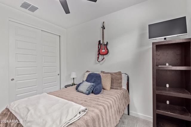 carpeted bedroom with a closet and ceiling fan