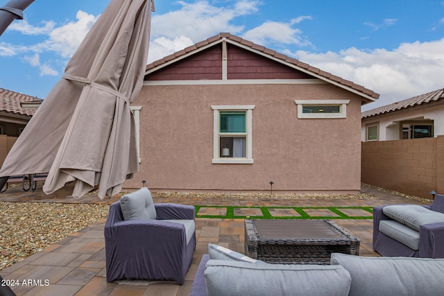 rear view of house with a patio and an outdoor living space