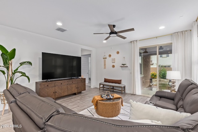 living room with ceiling fan and light wood-type flooring