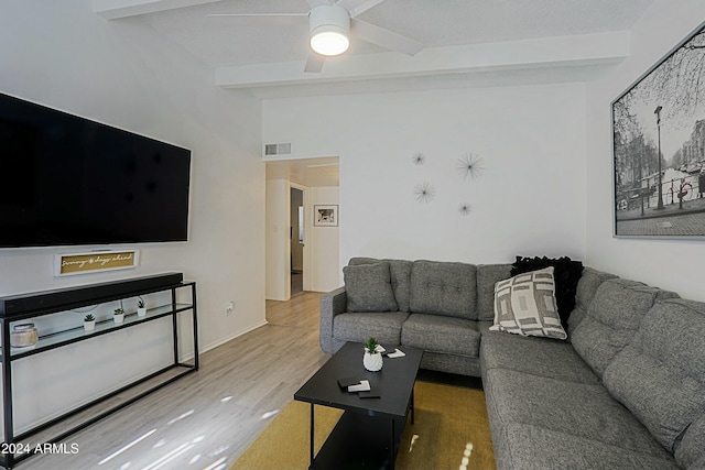 living room featuring ceiling fan, wood-type flooring, and lofted ceiling with beams