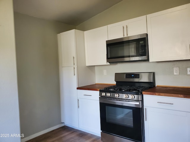 kitchen featuring wood counters, white cabinetry, and stainless steel appliances