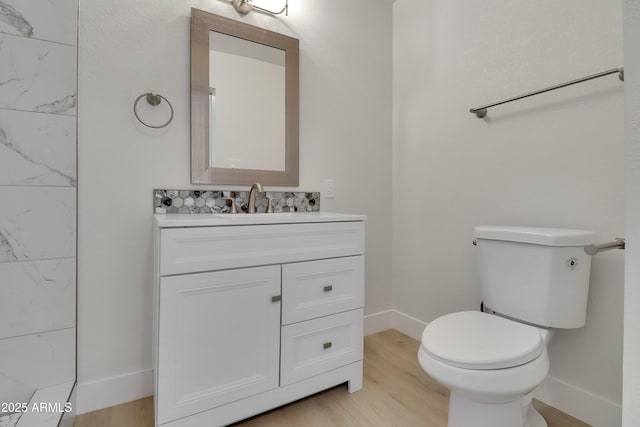 19118 W Fillmore St, Buckeye, AZ 85326 - bathroom with wood finished floors, vanity, baseboards, and toilet