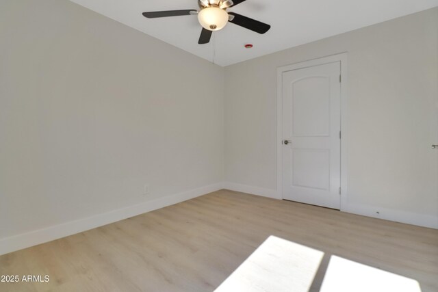 19118 W Fillmore St, Buckeye, AZ 85326 - empty room with wood finished floors, a ceiling fan, and baseboards