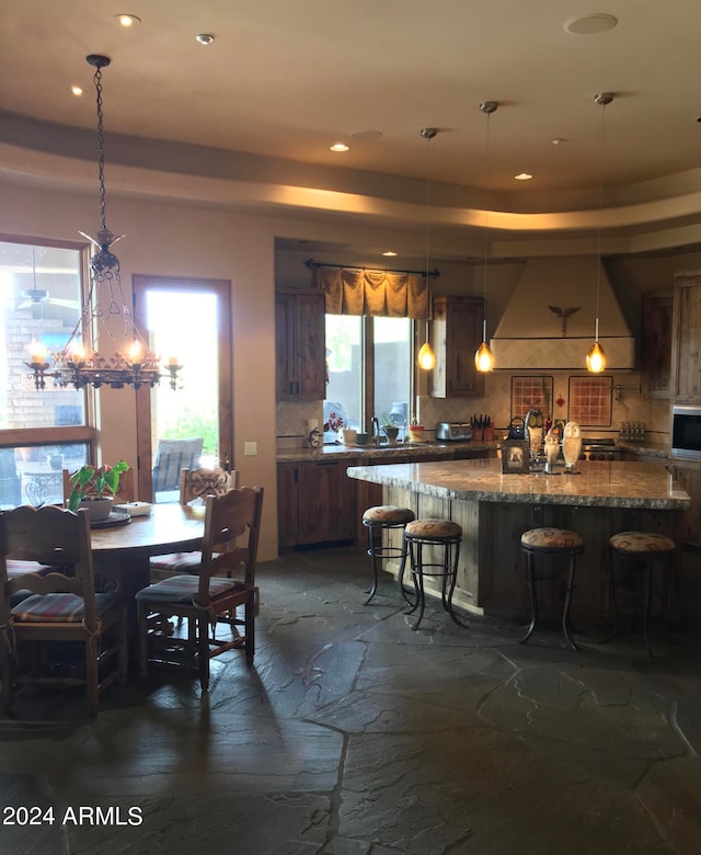 dining space with sink and a chandelier