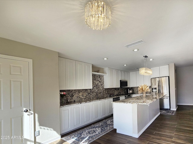 kitchen with white cabinetry, an inviting chandelier, decorative light fixtures, a kitchen island, and stainless steel appliances