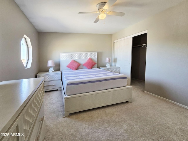 bedroom with ceiling fan, a closet, and light carpet