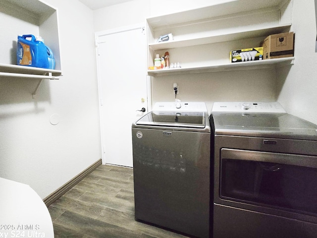 laundry area featuring dark hardwood / wood-style flooring and washing machine and dryer