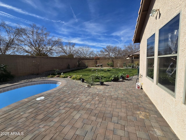 view of swimming pool featuring a lawn and a patio area