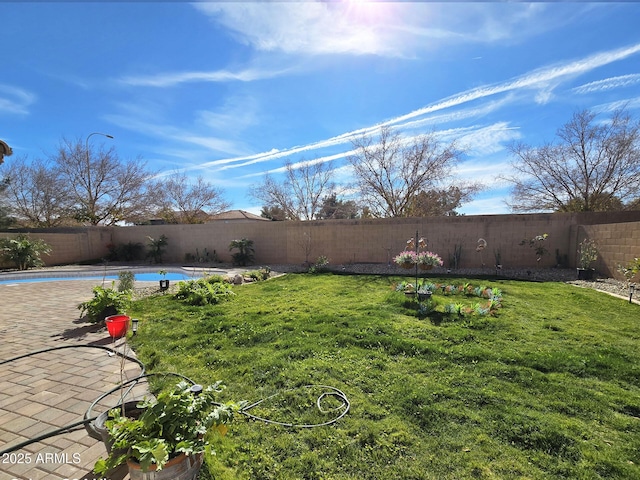 view of yard with a fenced in pool