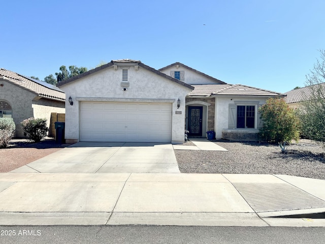 single story home with an attached garage, stucco siding, a tile roof, and concrete driveway