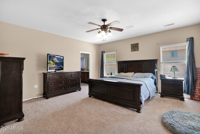bedroom featuring baseboards, visible vents, light carpet, and ceiling fan