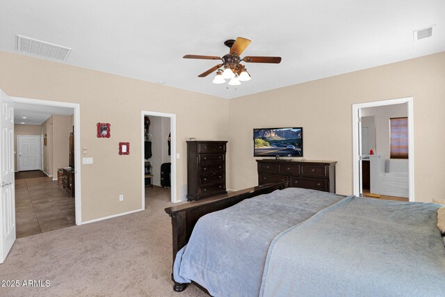 bedroom with baseboards, visible vents, a walk in closet, and carpet