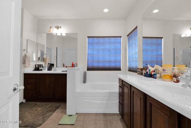full bathroom with a sink, tile patterned flooring, two vanities, a bath, and a stall shower