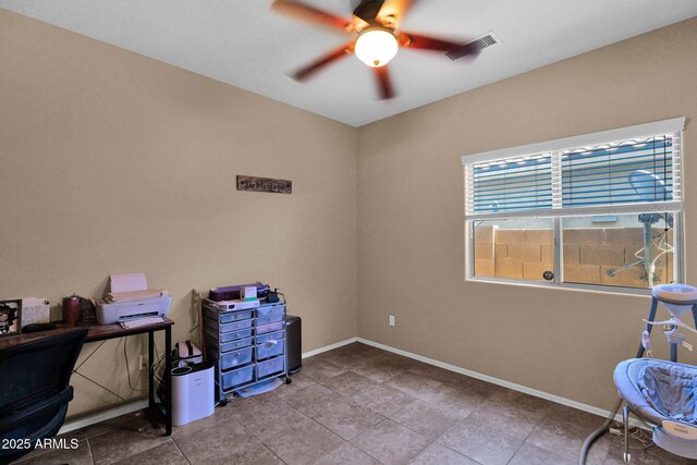 tiled office featuring visible vents, a ceiling fan, and baseboards