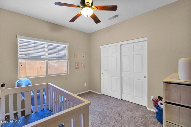 bedroom with ceiling fan, carpet floors, baseboards, visible vents, and a closet