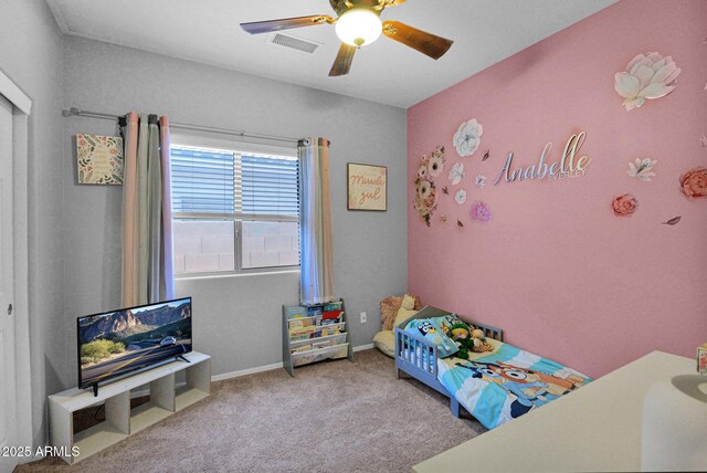 carpeted bedroom featuring ceiling fan and visible vents